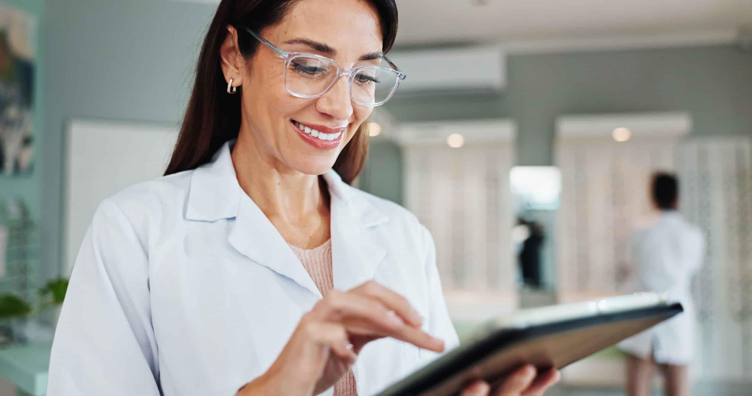 Smile, woman and optician on tablet for eye care, medical treatment or check eyesight test results. Digital technology, optometrist or store for ophthalmology research, healthy vision or prescription.