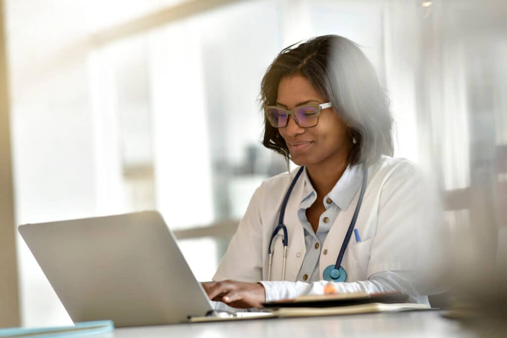 Physician reviewing electronic health record dashboard