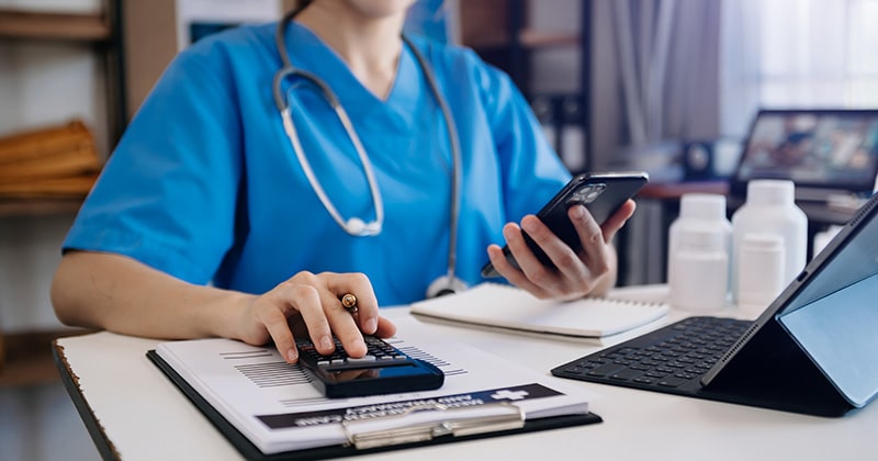 Doctor reviewing financial data related to healthcare costs.