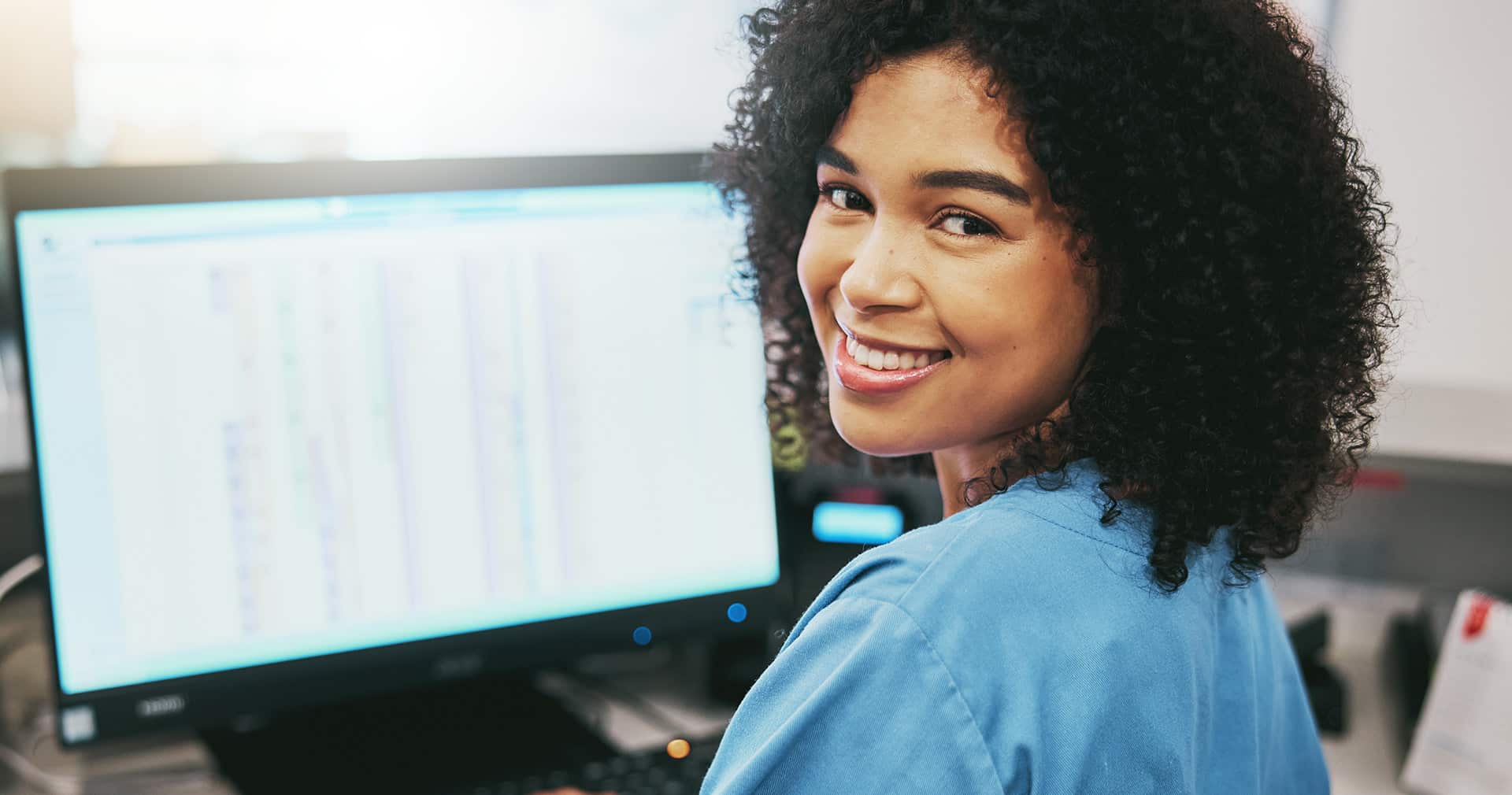 Doctor at her computer going over patients medical billing history.